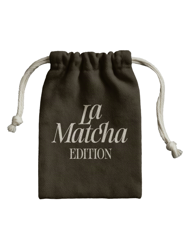 La Matcha Edition drawstring pouch mockup lettered in SLTF The Brachen, pale calligraphic serif on a dark olive fabric bag against black