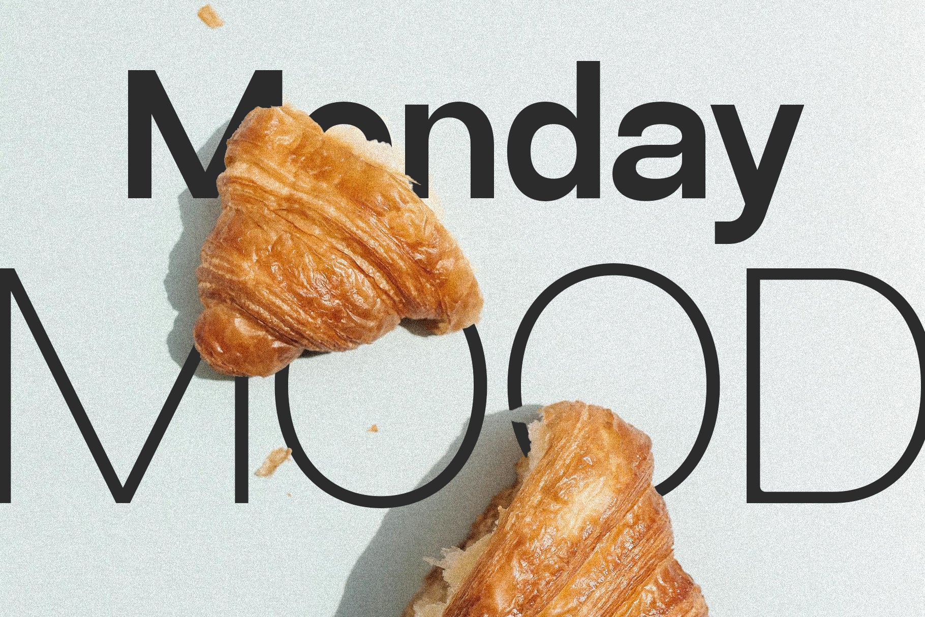 SLTF Ryecroft specimen on a pale mint ground. Monday is set in a heavy black weight across the top and MOOD in a thin outline weight below it, both at large size. Two croissants sit on the surface, one overlapping the M of Monday and one breaking into the O of MOOD, with crumbs scattered across the background and soft shadows falling to the right.