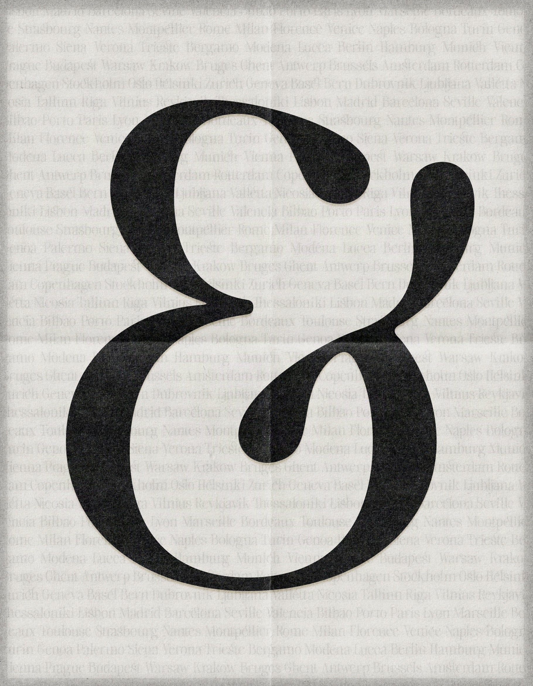 Large black SLTF The Brachen calligraphic ampersand printed on a folded newsprint textured paper