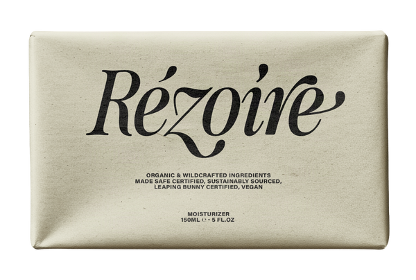 Rezoire moisturizer pouch mockup in SLTF The Brachen, dark swashed serif on a cream package against black with organic vegan ingredient text