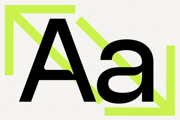 SLTF Ryecroft letterform specimen on a grainy off-white ground. A heavy black capital A and lowercase a are set side by side at large size, showing the two-story construction of the roman a. Lime green graphic elements frame the pair - an arrow bracket in the top left, a diagonal bar running behind the letters and a second bracket in the lower right.