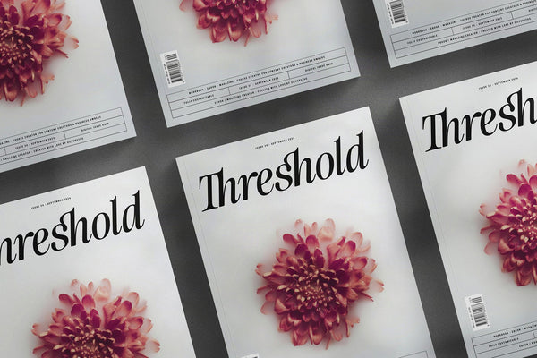 Threshold posters in SLTF The Brachen, the repeated word across sheets with magenta chrysanthemum flowers and a dramatic shadow